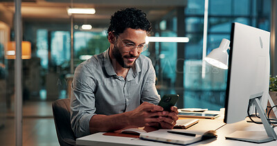 Buy stock photo Design, phone and typing with business man at desk in office for development at night. App, computer and text message with creative designer in dark workplace for communication or online planning