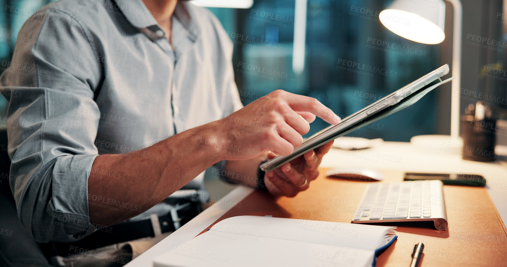 Buy stock photo Creative, online and hands with tablet, office and planning for article on website and working late. Scroll, research and person with tech for story, employee and journalist with deadline at night