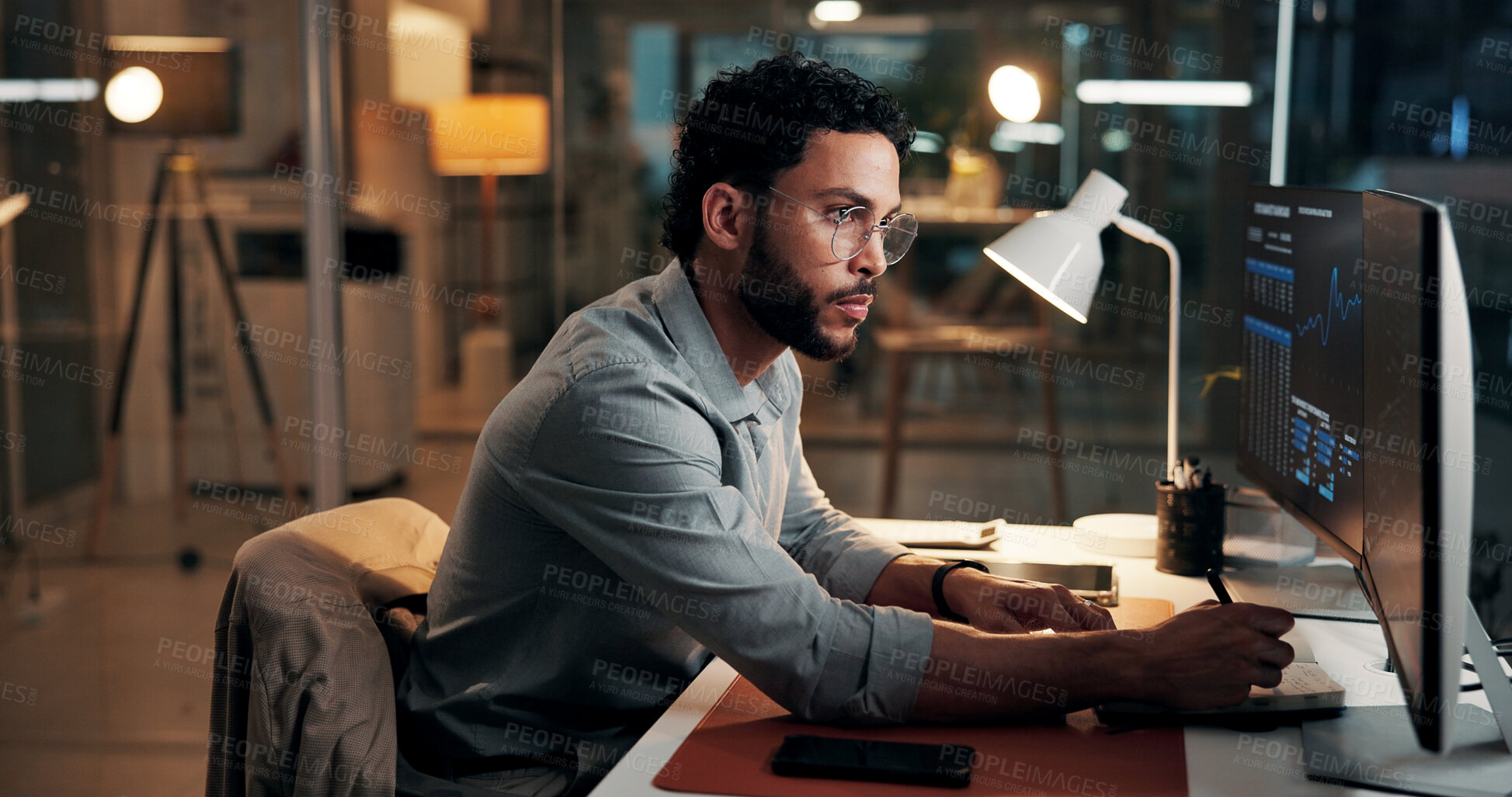 Buy stock photo Computer, trading and business man writing notes for stock market, finance data and night. Trader, notebook and serious person with desktop for investment chart, risk management or overtime in office