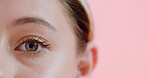Closeup, eye and woman in studio for optometry, glaucoma or astigmatism exam for vision. Mockup, portrait and female person on pink background with retina, eyesight test or wellness in ocular care.