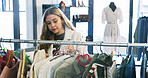 Shopping, sale and woman with clothes, search or outfit choice in designer boutique or thrift store. Fashion, decision and customer looking for discount, deal or checking fabric quality at mall