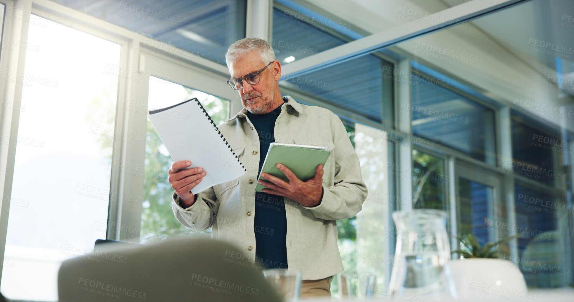 Buy stock photo Mature, businessman and documents with tablet in office for company policy, review or proposal. Man, CEO or executive reading with project brief or technology for business ideas, agenda or tasks