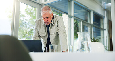 Buy stock photo Laptop, reading and serious with man in office for planning, problem solving or research as editor. Computer, publication and review with mature employee at desk in workplace for online magazine