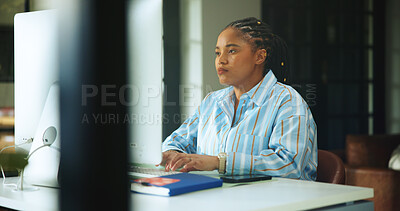 Buy stock photo Computer, remote work and typing with black woman at desk in home office for planning or research. Reading, small business and review with serious African freelance in apartment for startup report