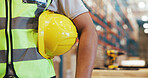 Helmet, logistics and arm of man in warehouse for safety manager, contractor and packing technician. Supply chain, ppe protection and hardhat gear with person in factory for distribution and bokeh