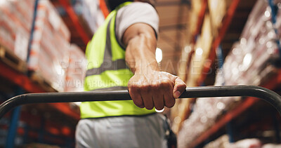 Buy stock photo Hand, logistics and trolley with man in warehouse aisle for delivery, distribution or shipping. Boxes, shelves and stock with person pulling cart in supply chain depot for export or import from below
