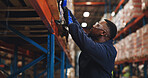 Warehouse, black man and check shelf for stock, inventory management or supply chain. Distribution, worker and storage inspection for quality control, shipping or logistics with cargo in industry