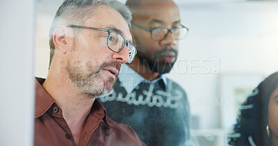 Buy stock photo Man, team and writing on glass wall at office, planning or insight with risk management solution. Mature person, group and notes on board for problem solving, strategy or feedback at insurance agency