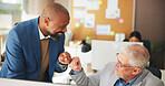 Business, people and fist bump with computer in office for good news, article success and celebration. Mature men, coworking and team congratulations for story funding, achievement and publication