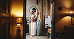 Couple, smile and hug in bathroom at hotel for weekend getaway, connection or bonding together. Happy, married people and embrace in lodge for healthy relationship, holiday or vacation accommodation.
