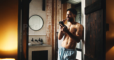Buy stock photo Phone, brushing teeth and man in home for dental wellness, hygiene and morning news. Mobile, cleaning mouth and shirtless person by bathroom doorway for oral care, health and reading message online