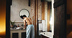 Back, basin and doorway with shirtless man in bathroom of hotel room for hygiene or morning routine. Entrance, start and wake up with person at sink for accommodation, break or hospitality as guest