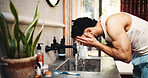 Man, washing face and water with splash in bathroom for grooming, skincare or morning routine. Male person, cleaning or rinse with tap, faucet or mineral liquid for hygiene, bacteria or dirt removal