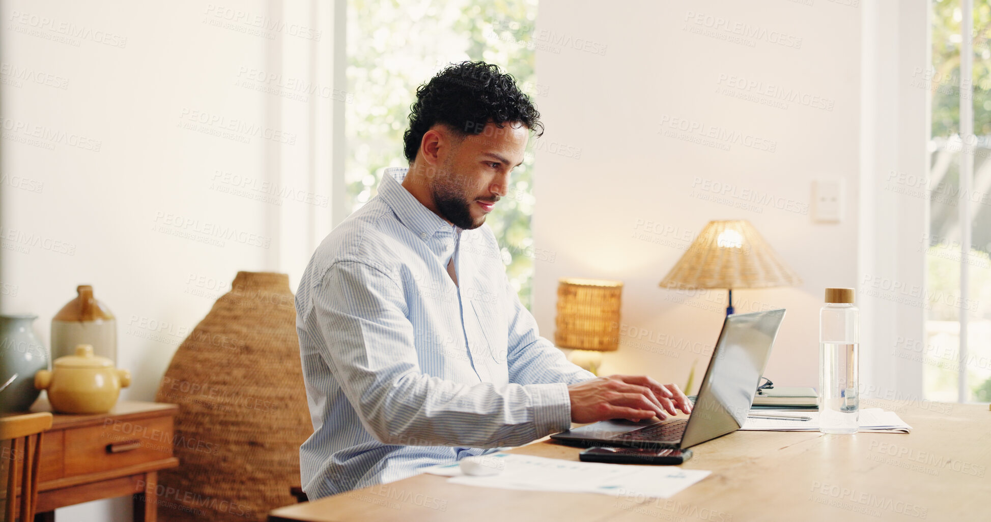 Buy stock photo Laptop, remote work and typing with business man in home office for feedback, research or review. Computer, planning and reading with freelance employee at desk in apartment for startup proposal