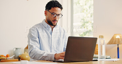 Buy stock photo Laptop, reading and typing with business man in home office for problem solving or research. Computer, glasses and remote work with serious freelancer at desk in apartment for startup planning