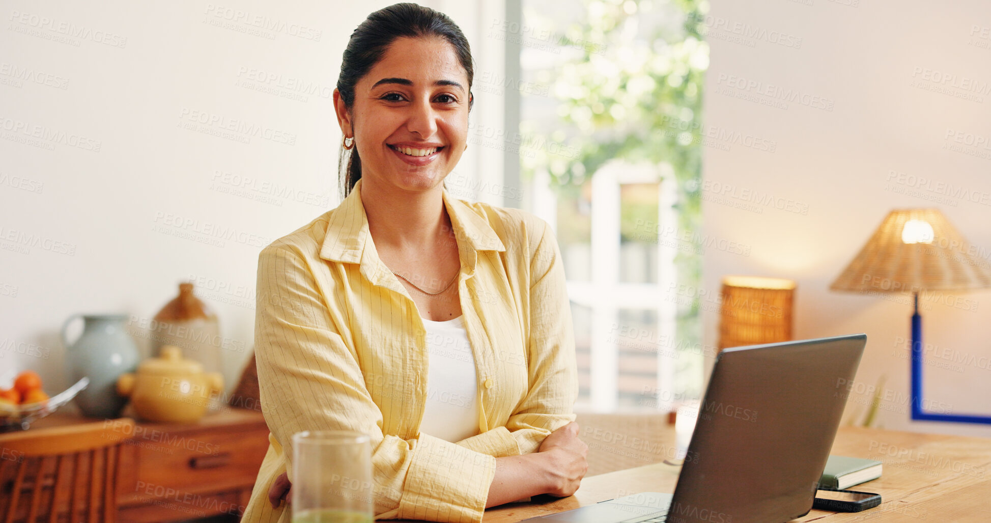 Buy stock photo Arms crossed, portrait and smile of business woman in home office for online planning or research. Computer, confident and remote work with happy Indian freelancer at desk in apartment for startup