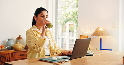 Buy stock photo Laptop, reading and smoothie with business woman in home office for detox drink or research. Computer, green juice beverage and remote work with Indian freelancer at desk in apartment for startup