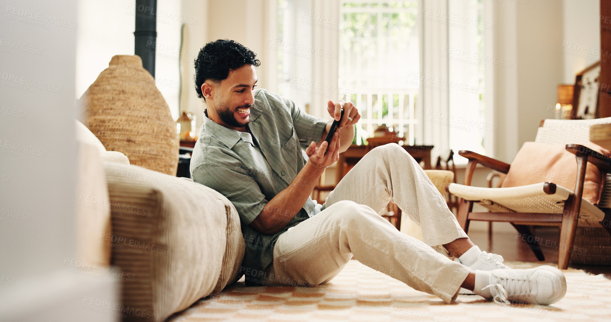 Buy stock photo Gaming, phone and relax with man in home for streaming service, esports app and connection. Sports gamer, subscription and entertainment with person in living room of apartment for online contest