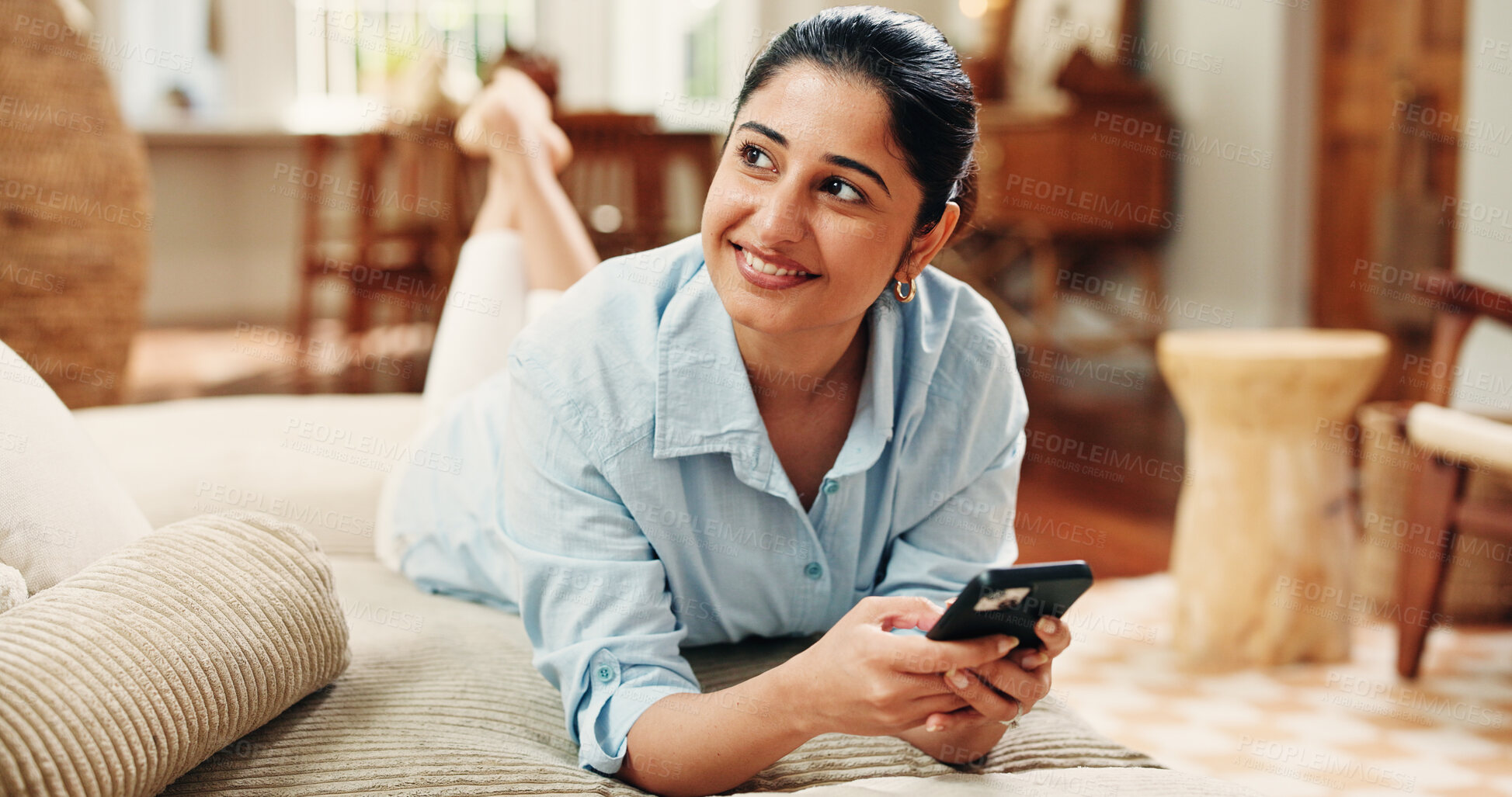 Buy stock photo Happy woman, relax and thinking with phone on sofa for social media post, online dating or contemplation. Person, smile and reflection in home with tech, text message reply and virtual chat response.