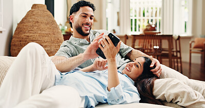 Buy stock photo Couple, phone and relax on sofa, happy and scroll for funny video, meme or post in living room at house. Woman, man and smartphone with app, laugh and bonding with social media on couch at apartment