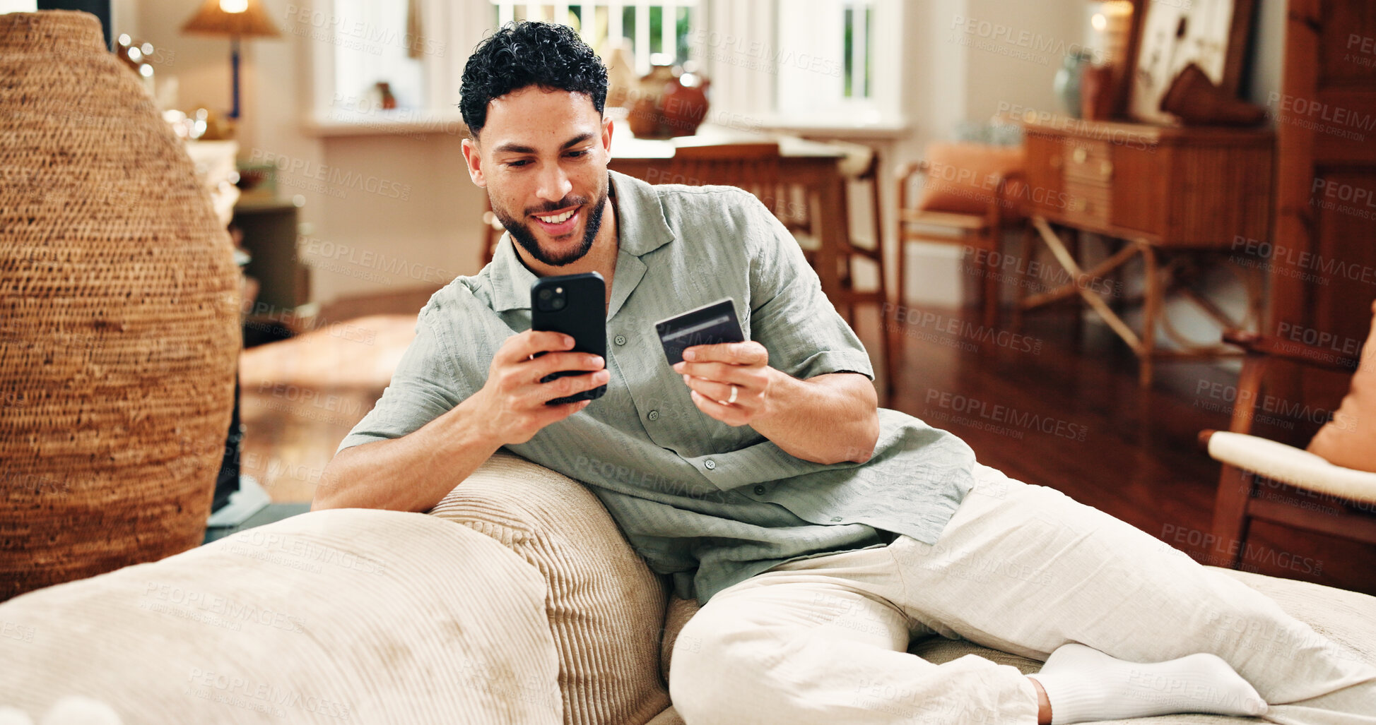 Buy stock photo Happy man, credit card and payment with phone in home for online shopping, purchase or internet banking. Fintech, person typing or eft transaction in sofa with tech, ecommerce mobile app or checkout.
