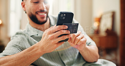 Buy stock photo Credit card, happy or man on sofa with phone, online banking or payment in eft transaction. Ecommerce, easy purchase or male person at house with tech, remote or debit details for cashless service.