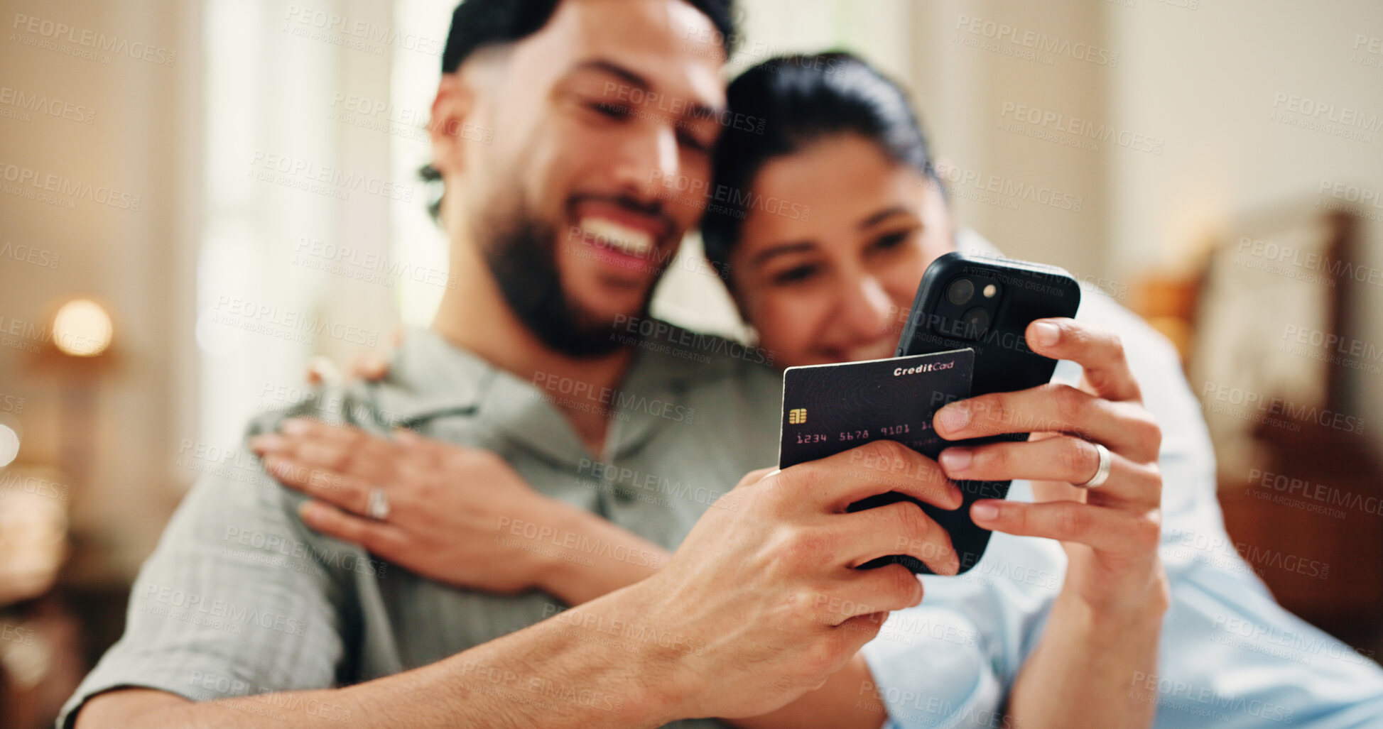Buy stock photo Happy couple, credit card and payment with phone in home for online shopping sale, purchase or embrace. Fintech, married people and hug in apartment with tech, ecommerce discount and eft transaction.