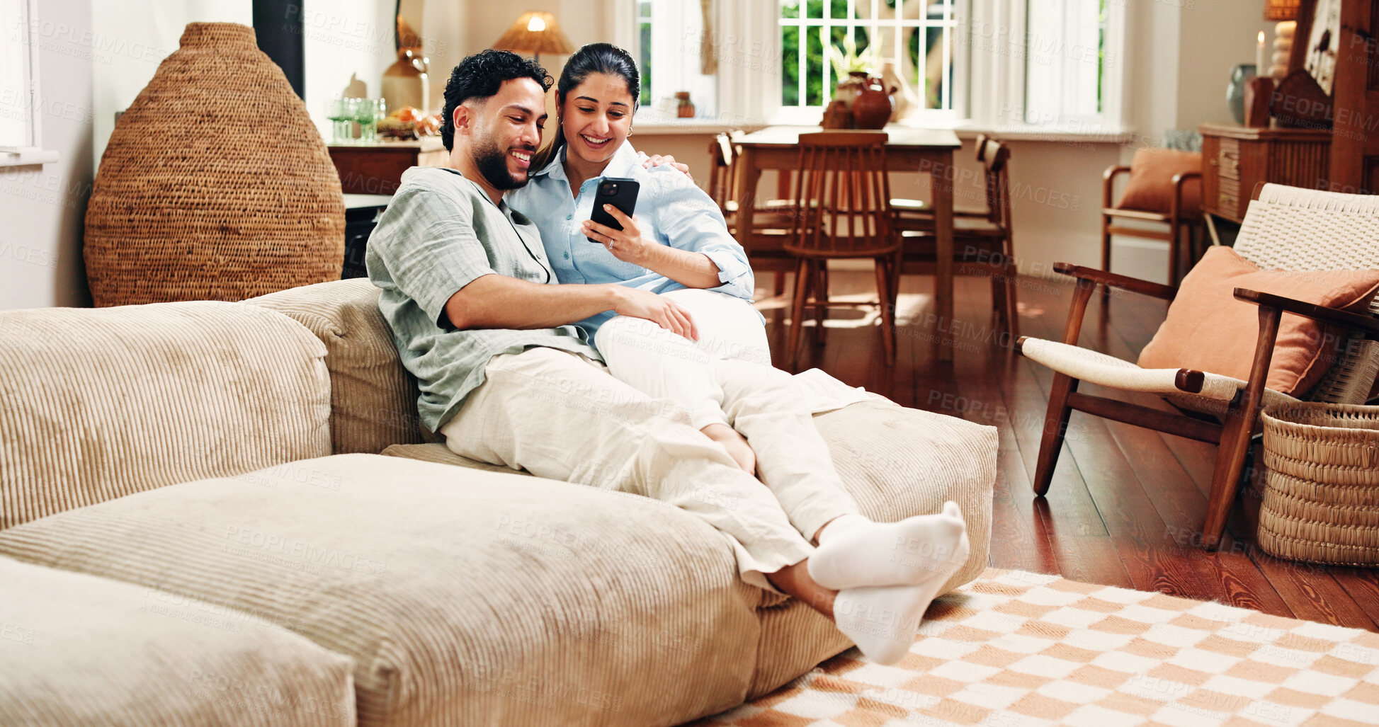 Buy stock photo Couple, phone and relax on couch, texting and scroll for funny video, bonding or post in living room at house. Happy woman, man and smartphone with mobile app, chat or meme on social network in home