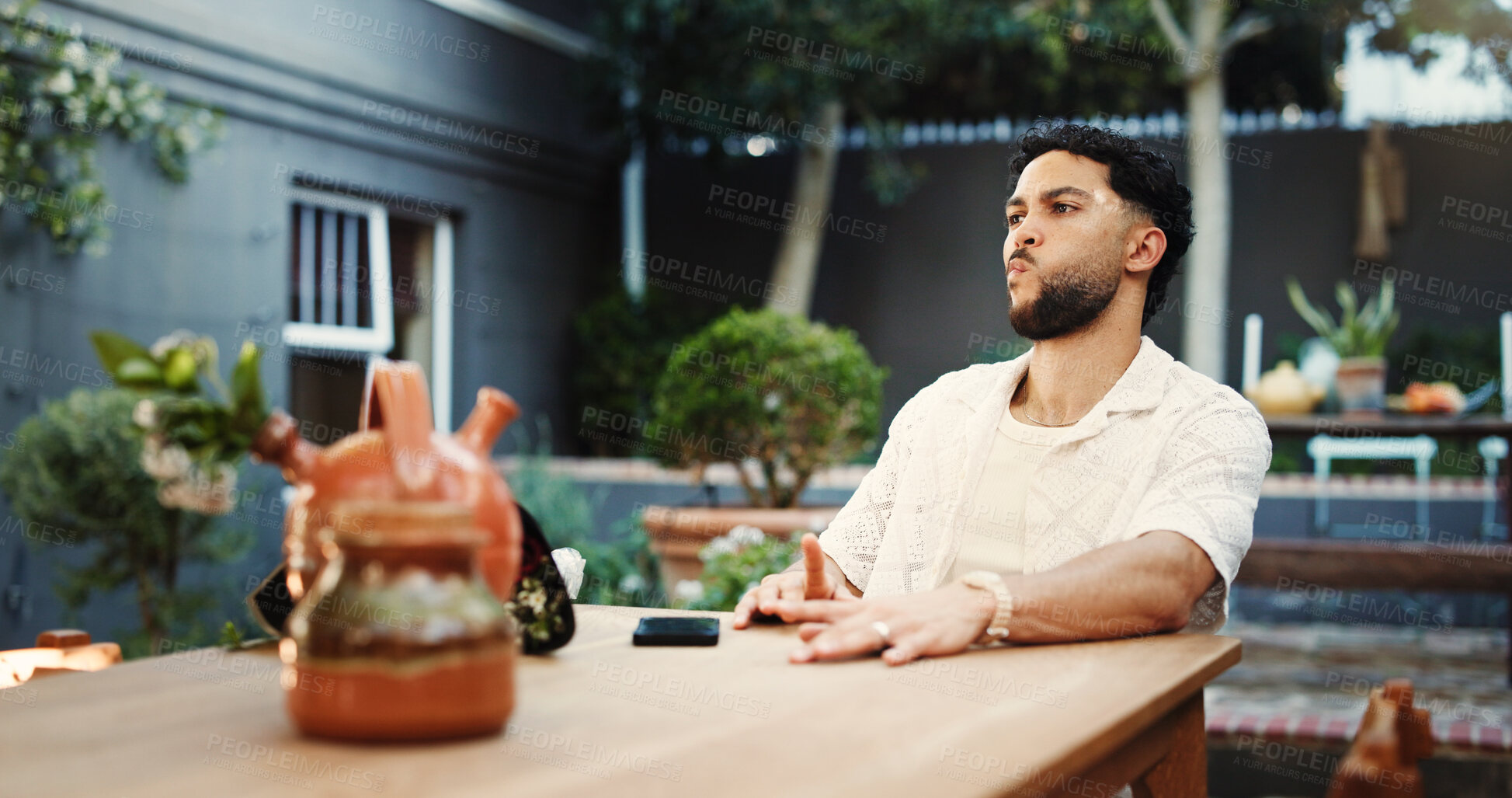 Buy stock photo Frustrated, man and waiting with delay, restaurant and annoyed by late date, valentines day or roses. Diner, reservation and person with bouquet for anniversary, angry or upset with appointment