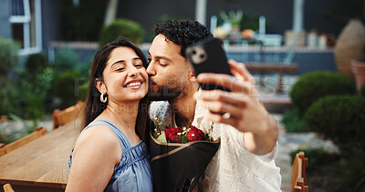 Buy stock photo Flowers, kiss and selfie with couple at restaurant together anniversary date, memories or romance. Love, photograph and rose bouquet with people outdoor for celebration, milestone or social media
