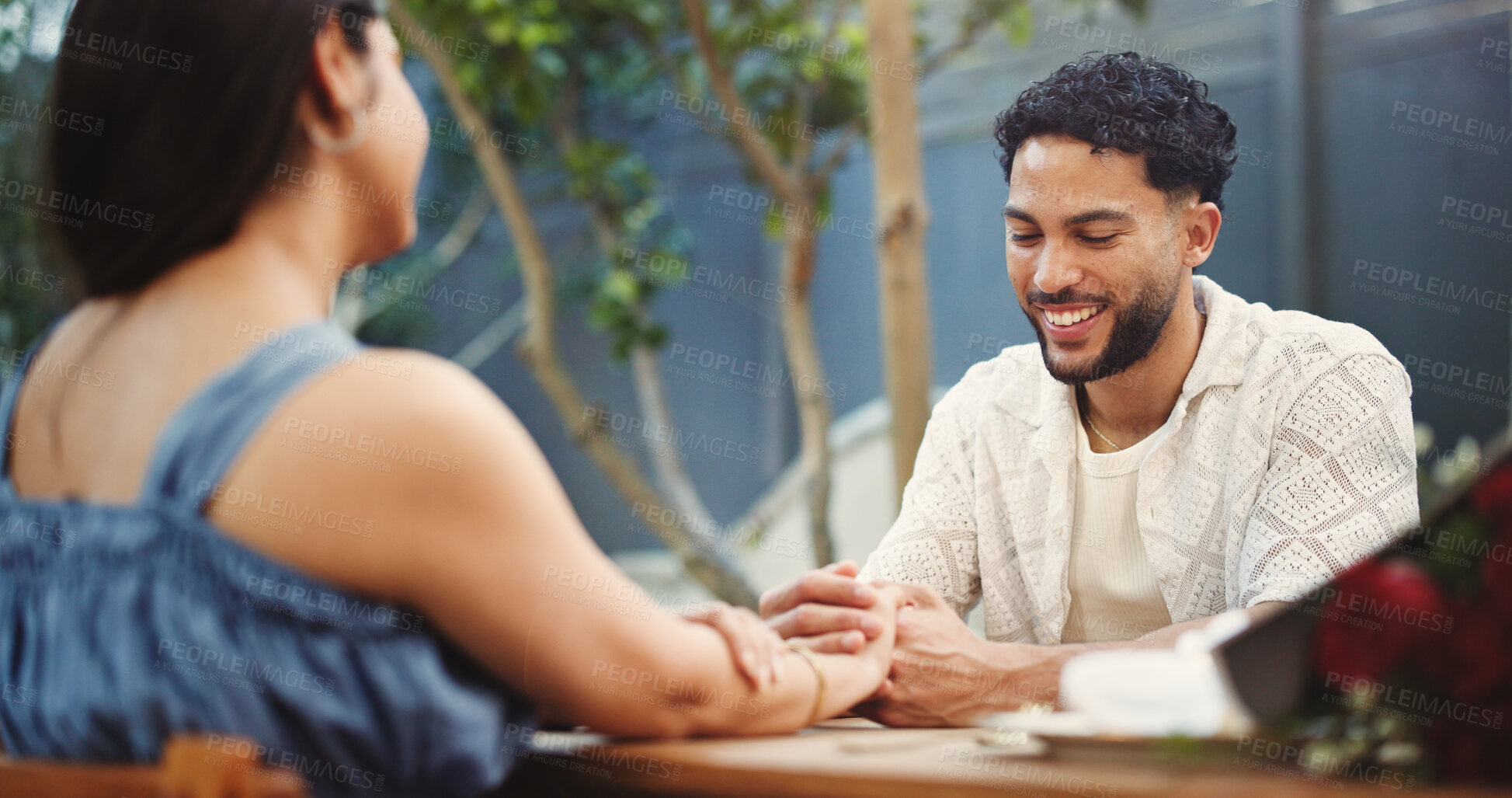 Buy stock photo Couple, holding hands and happy on date at restaurant with bouquet, discussion and relationship milestone. Man, woman and smile for connection with bonding, trust or flowers on anniversary at diner