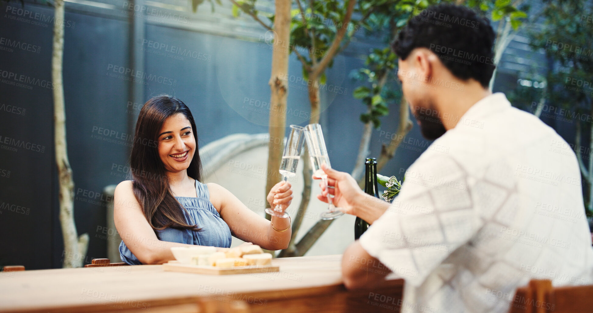 Buy stock photo Bonding, dating and toast with couple at table of restaurant together for celebration or romance. Cheers, love and relationship with happy people clink glass for hospitality, milestone or support