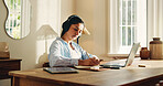 Headphones, remote work and writing with woman in home office for journalism or publication. Notes, pen and planning with freelance journalist at desk in study of apartment for article research