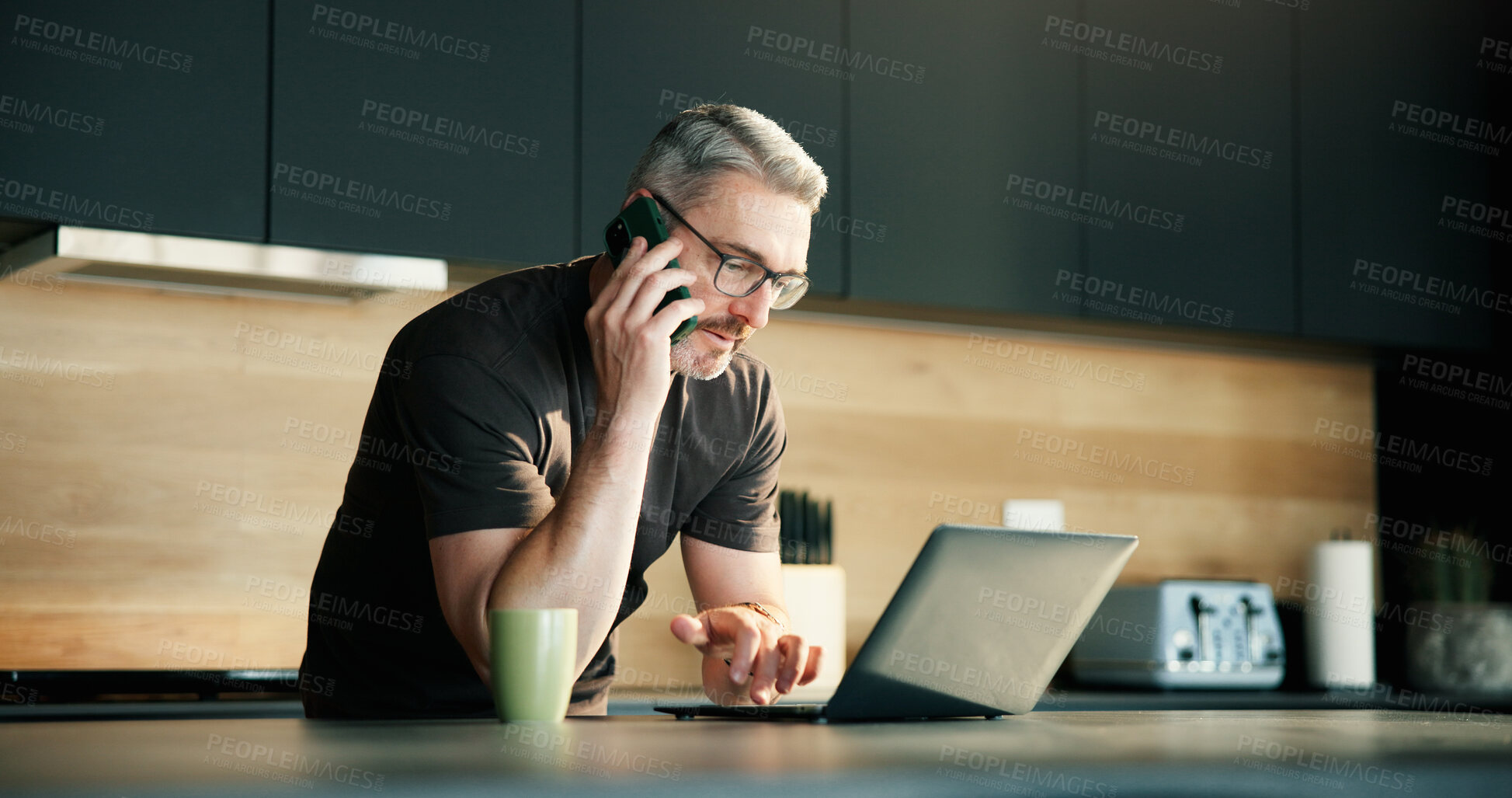 Buy stock photo Phone call, review or man in house with laptop, source contact or magazine update in remote work. WFH, mature or journalist in kitchen with tech, networking or story pitch for digital publication.