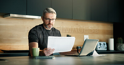 Buy stock photo Documents, laptop and remote work with man in kitchen of home for planning, report or research. Computer, paperwork and reading with mature freelancer in apartment for schedule or startup review