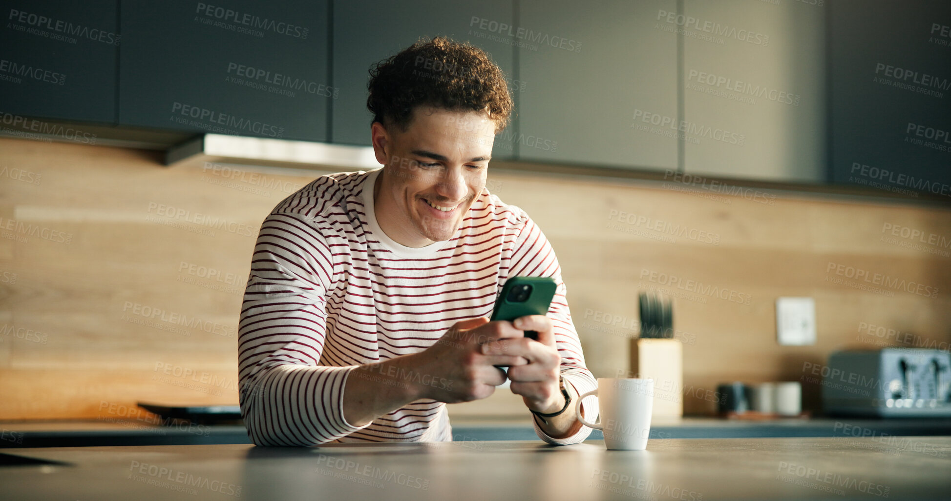 Buy stock photo Man, smile and typing in kitchen with phone for social media notification, text message or online chat. Happy person, browse or scroll with tech in home for mobile app, virtual communication or blog.