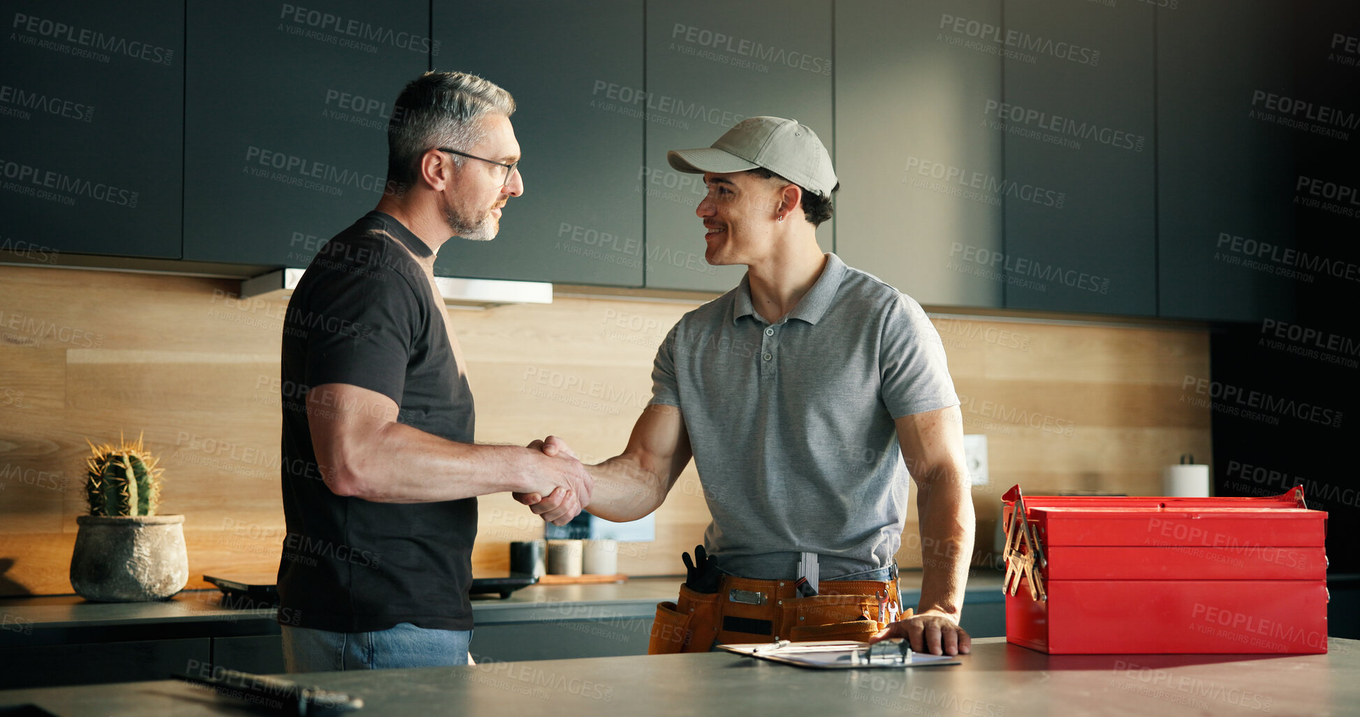 Buy stock photo Men, plumber and client with handshake in kitchen for solution, maintenance and leak repair. Homeowner, handyman and shaking hands in home for help, job completion and thank you for call out service