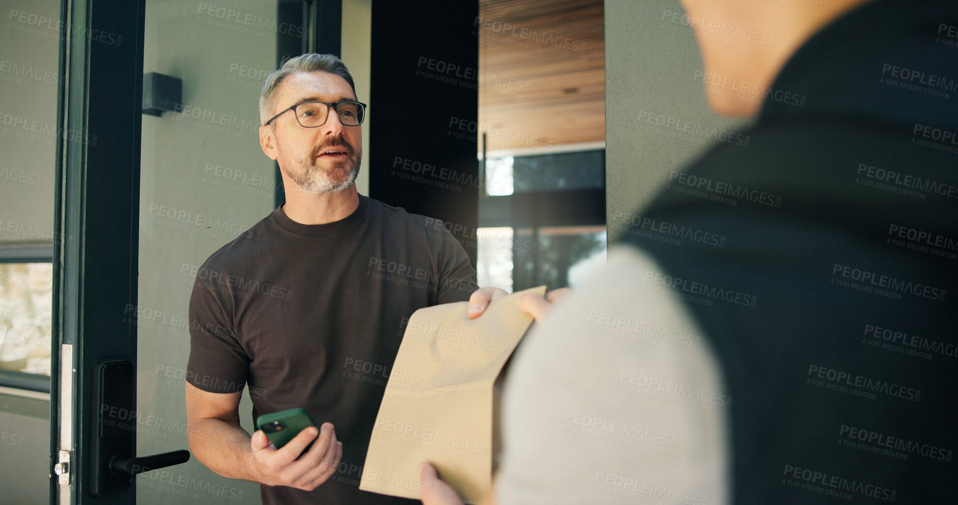 Buy stock photo Delivery, package and phone with man at front door of home for receipt of online order in bag. Courier, parcel and retail shipping with customer at entrance to apartment for ecommerce purchase