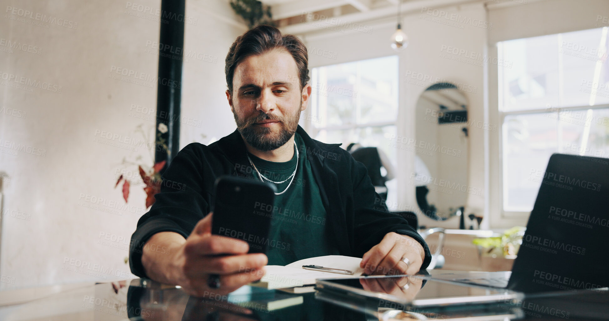 Buy stock photo Phone, laptop and man barber in salon with communication for appointment schedule with client. Cellphone, computer and hairdresser with contact, email or connectivity on mobile app at beauty parlor.