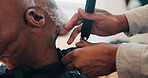 Hands, barber and clippers for beard, trim and facial hair removal with grooming at small business. People, senior client and customer experience at shop, shaving or cutting for hairstyle at salon