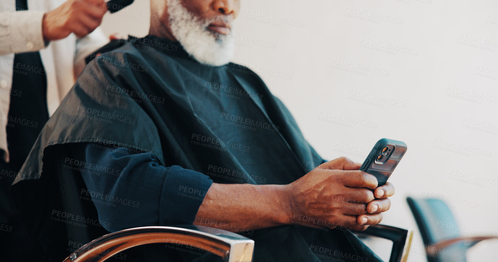 Buy stock photo Hairdresser, people and hands with phone at barber, check notification and social media to pass time. Connection, hair salon and man with mobile to watch video, customer haircut and browsing internet