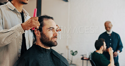 Buy stock photo Hair salon, service and barber with client at appointment for grooming, haircut and trim for beard. Hairdresser, tools and person with man in chair for styling, shave and treatment in barbershop