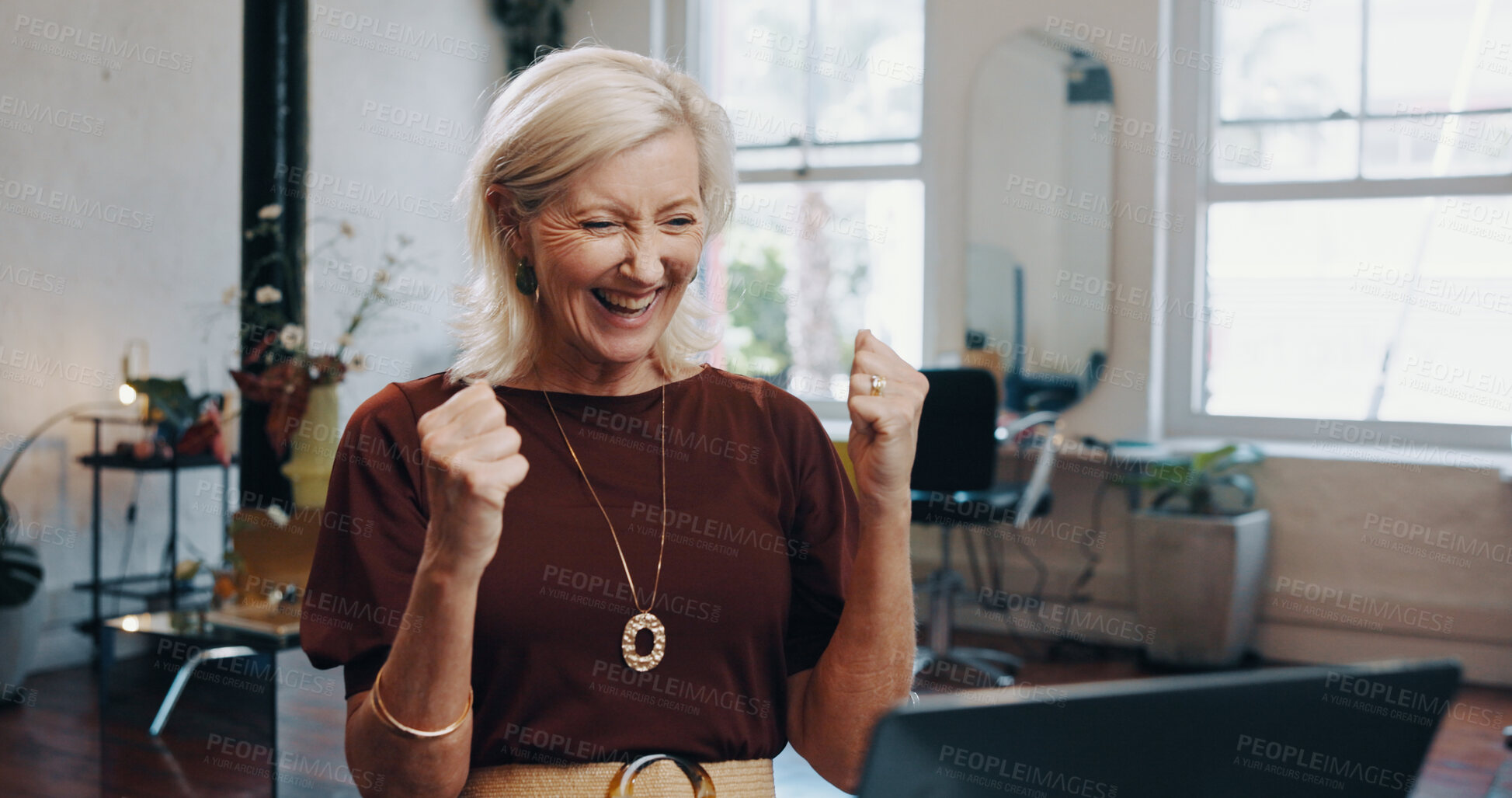 Buy stock photo Fist pump, laptop and success with woman at desk in small business startup for goals or victory. Celebration, computer and target with mature employee in office for bonus, milestone or motivation