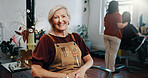 Mature woman, portrait and smile at hairdresser with career, confidence and pride for grooming service at store. Person, entrepreneur and happy at salon, job or apron for hairstyle at beauty parlor