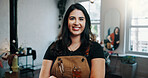 Woman, portrait and happy at hairdresser in store, confidence and career with grooming services. Person, entrepreneur and smile at salon, tools or apron with pride, job or hairstyle at beauty parlor