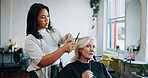 Mature woman, hairdresser and scissors with talk at salon, hairstyle and decision for change. People, hair care and grooming services with tools, discussion and customer experience at beauty parlor