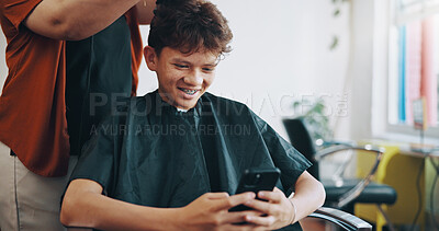 Buy stock photo Salon, hairdresser and boy with smartphone, smile and message to contact, social media and app. Kid, hair maintenance and appointment with cellphone, treatment and texting with online chatting