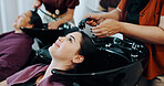 Hairdresser, customer or women at beauty salon basin, professional service or washing scalp to clean. Rinse, shampoo treatment or client with stylist for hair care routine, people or faucet for water