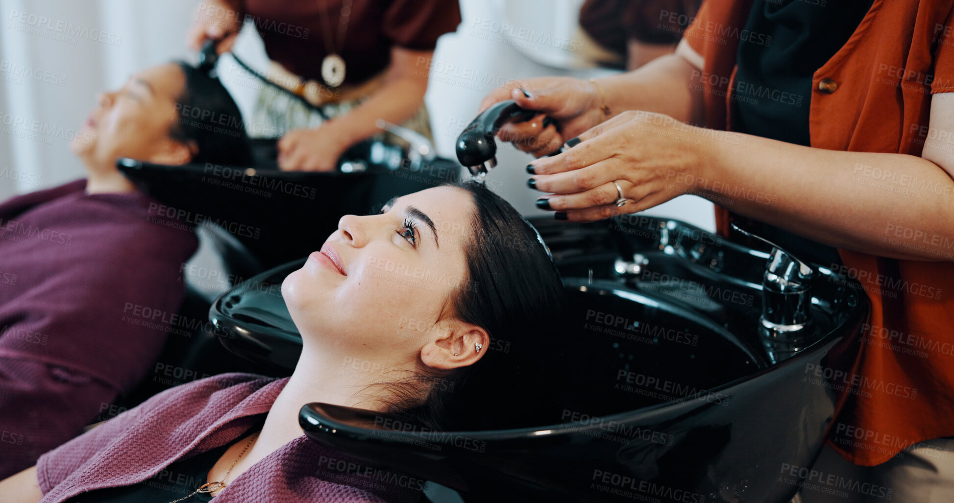 Buy stock photo Hairdresser, customer or women at beauty salon basin, professional service or washing scalp to clean. Rinse, shampoo treatment or client with stylist for hair care routine, people or faucet for water