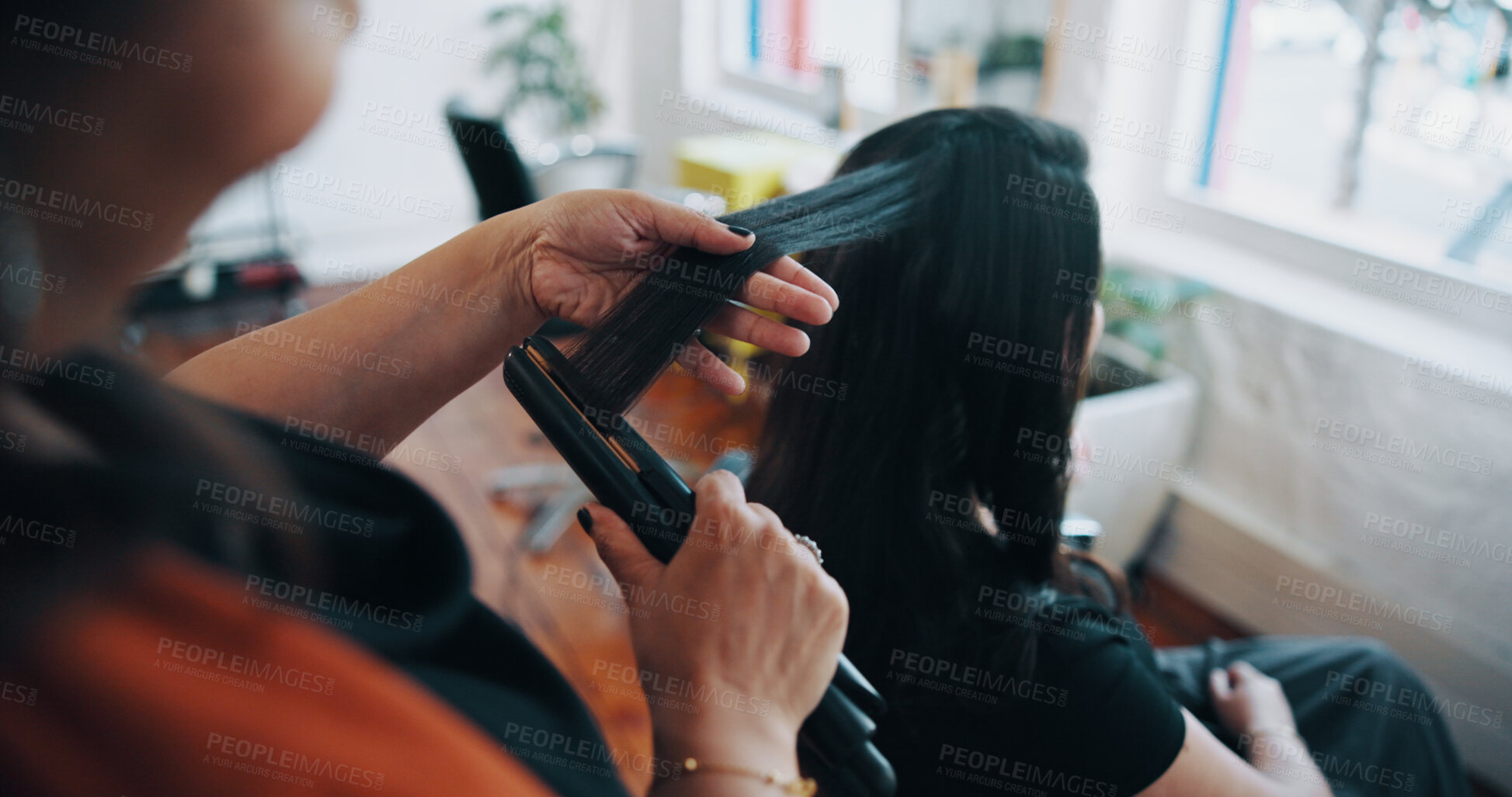 Buy stock photo Hands, hairstylist and straightener with woman in salon for cosmetology, beauty and grooming. Hairdresser, parlor and customer makeover with people in store for hair care, relax and flat iron